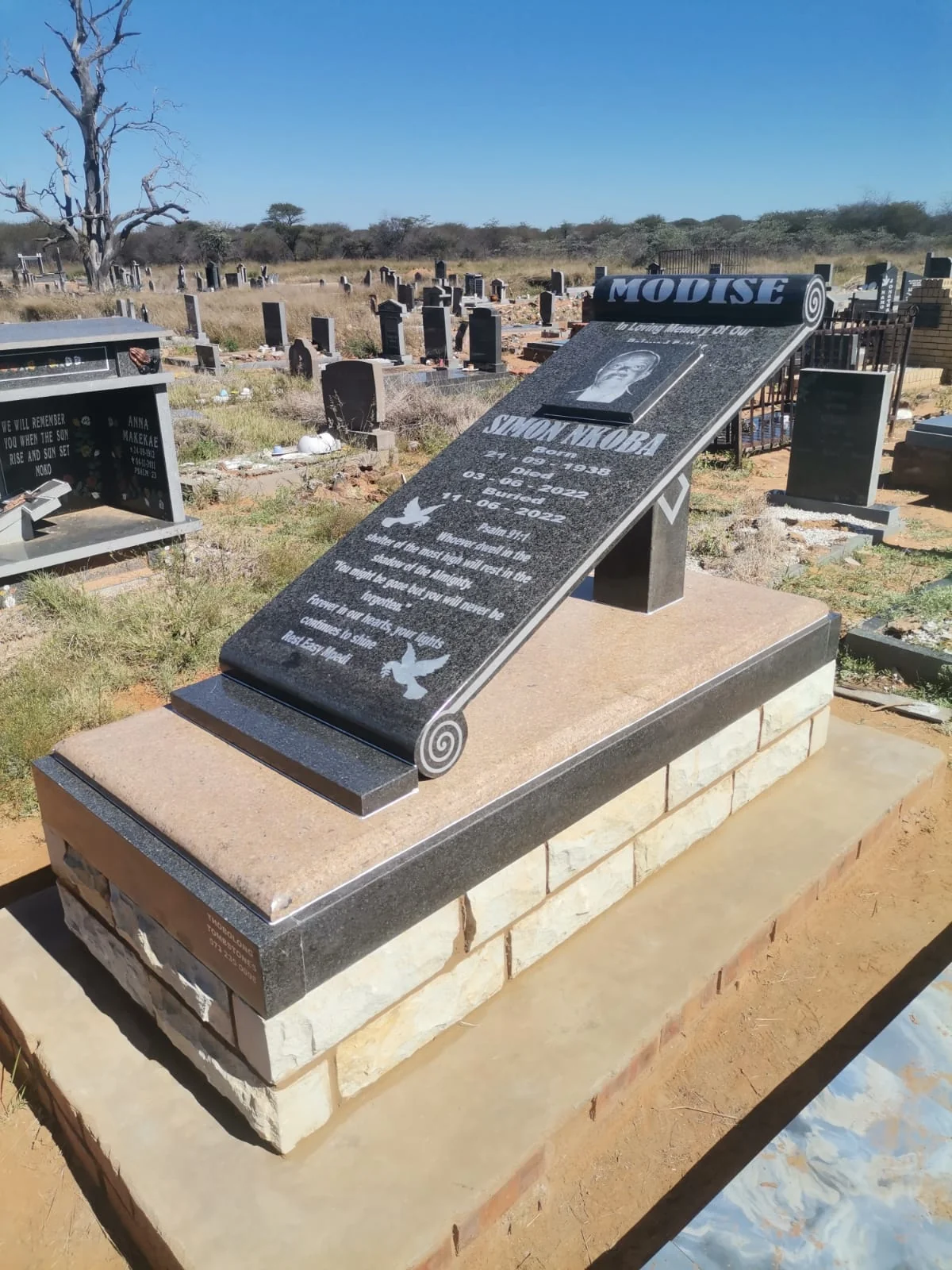 Polished black granite tombstone with a luxurious, mirror-like finish