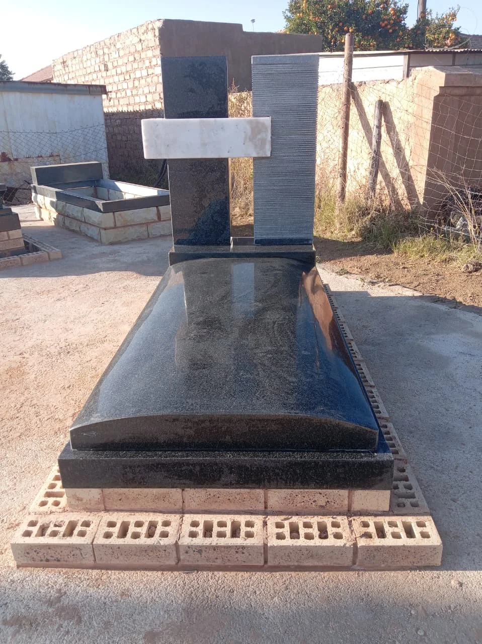 Double headstone memorial for a couple in a serene garden